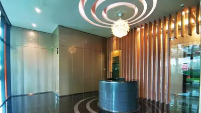 a lobby with a chandelier and a barrel in a building at Sky Suites KLCC by iRent365 in Kuala Lumpur