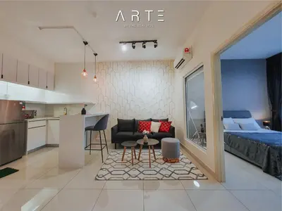 a living room and kitchen with a couch and a table at Arte Mont Kiara Luxury Suite with Heated Jacuzzi Pods - Free Parking - Next to MITEC- by The Stay Hub in Kuala Lumpur