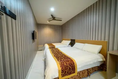 a bedroom with two beds and a ceiling fan at Hotel LBS in Kuala Lumpur