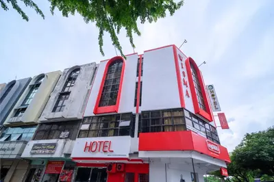 a hotel with a red and white building at Hotel LBS in Kuala Lumpur