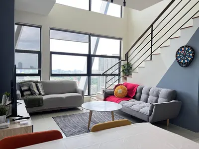 a living room with two couches and a table at Arte Mont Kiara by RKD HOME in Kuala Lumpur