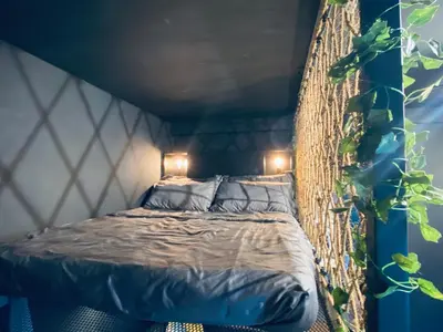 a bedroom with a bed in a hanging bed frame at Arte Mont Kiara by RKD HOME in Kuala Lumpur