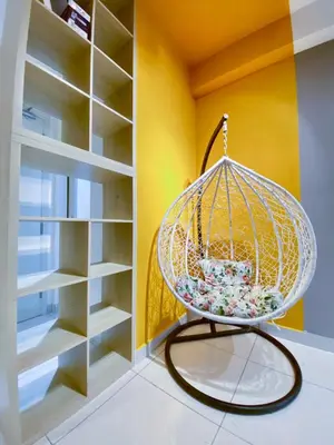a yellow room with a white closet with a chandelier at Arte Mont Kiara by RKD HOME in Kuala Lumpur