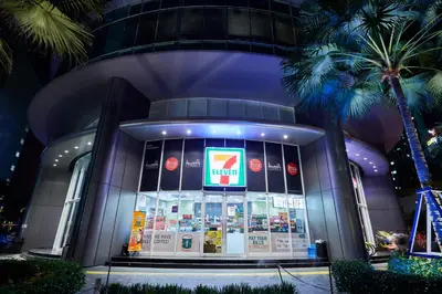 a gas station in front of a building with palm trees at Vortex KLCC Area in Kuala Lumpur