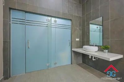 a bathroom with a shower and a sink and a mirror at Astoria Ampang By Grabstay in Kuala Lumpur