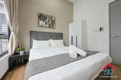 a bedroom with a large bed with white sheets and pillows at Astoria Ampang By Grabstay in Kuala Lumpur