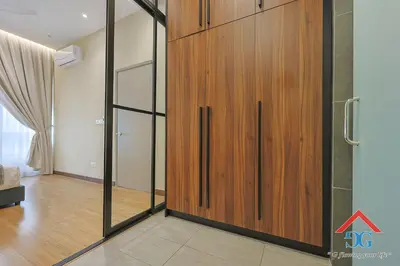 a large wooden closet with glass doors in a room at Astoria Ampang By Grabstay in Kuala Lumpur
