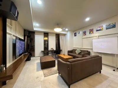 a living room with a couch and a flat screen tv at Tropicana The Residence By Klcc in Kuala Lumpur
