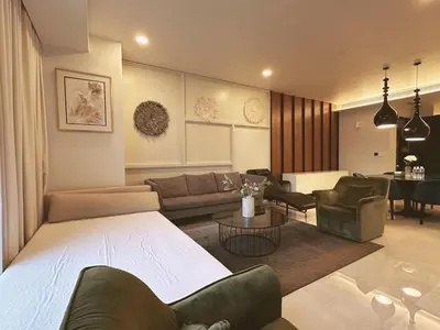a living room with a couch and chairs and a table at Tropicana The Residence By Klcc in Kuala Lumpur