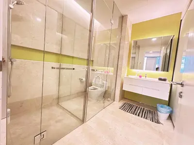 a bathroom with a shower with a toilet and a sink at Tropicana The Residence By Klcc in Kuala Lumpur