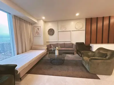 a living room with a bed and a couch and chairs at Tropicana The Residence By Klcc in Kuala Lumpur