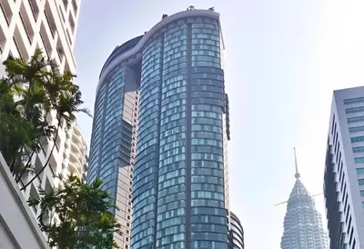 a tall glass building in the middle of a city at Sky Suite KLCC Studio Suite in Kuala Lumpur