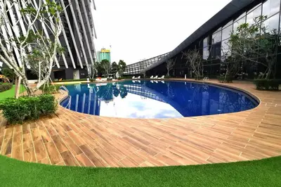 a large swimming pool in the middle of a building at HappyHome @ Arte Mont Kiara Kuala Lumpur Hartamas Damansara in Kuala Lumpur
