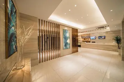a lobby of a building with a vase at Ramada Encore by Wyndham Chinatown Kuala Lumpur in Kuala Lumpur