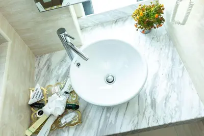 a bathroom counter with a sink and a white counter top at Ramada Encore by Wyndham Chinatown Kuala Lumpur in Kuala Lumpur