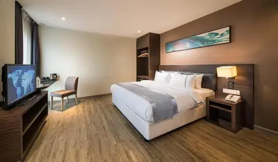 a hotel room with a large bed and a television at Ramada Encore by Wyndham Chinatown Kuala Lumpur in Kuala Lumpur