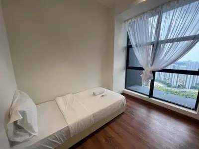 a bedroom with a bed and a large window at Arte Mont Kiara by CozyNest in Kuala Lumpur
