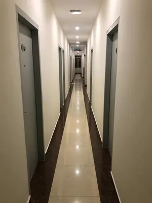 a hallway of a building with doors and a long corridor at DUTA HOTEL in Kuala Lumpur