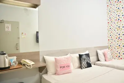 a room with a couch with pillows on it at DUTA HOTEL in Kuala Lumpur