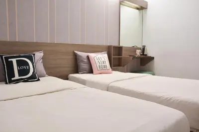 two beds sitting next to each other in a room at DUTA HOTEL in Kuala Lumpur