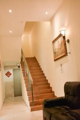 a staircase in a living room with a couch at DUTA HOTEL in Kuala Lumpur