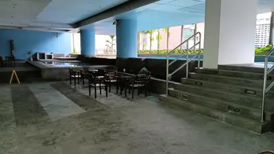 a dining room with chairs and tables and stairs at One Maxim Residence at Taragon in Kuala Lumpur