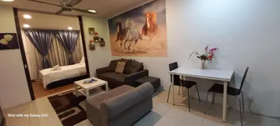 a living room with a couch and a table at One Maxim Residence at Taragon in Kuala Lumpur