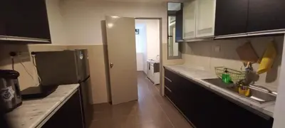 a kitchen with a refrigerator and a sink in it at One Maxim Residence at Taragon in Kuala Lumpur