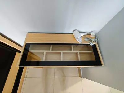 a wooden shelf in a corner of a room at Razak City Residence at Sungai Besi, Kuala Lumpur by Liberty Homes in Kuala Lumpur