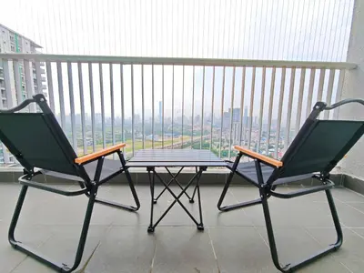 two chairs and a table on top of a balcony at Razak City Residence at Sungai Besi, Kuala Lumpur by Liberty Homes in Kuala Lumpur