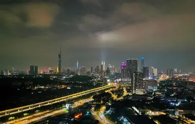 a city skyline at night with a busy freeway at Razak City Residence at Sungai Besi, Kuala Lumpur by Liberty Homes in Kuala Lumpur
