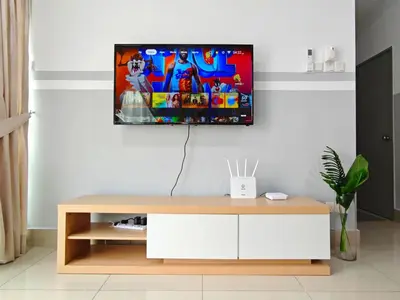 a living room with a tv on a wall at Razak City Residence at Sungai Besi, Kuala Lumpur by Liberty Homes in Kuala Lumpur