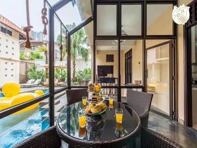 a dining room with a table and a pool at 6BR San He Yuan RIAD Private Pool Villa KLCC View by Verano in Kuala Lumpur