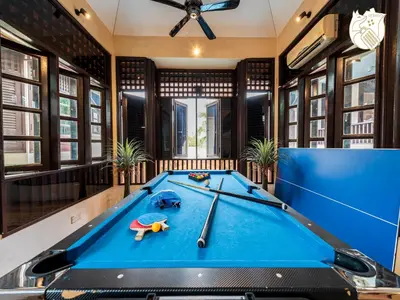 a pool table in a room with a ping pong ball at 6BR San He Yuan RIAD Private Pool Villa KLCC View by Verano in Kuala Lumpur