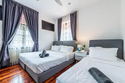 two beds in a room with two windows at 6BR San He Yuan RIAD Private Pool Villa KLCC View by Verano in Kuala Lumpur