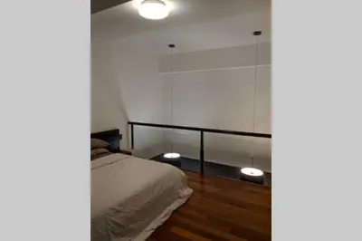 a bedroom with a bed and a glass wall at Cozy designer loft near KL city center in Ampang