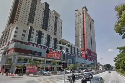 a busy city street with tall buildings and motorcycles at Cozy designer loft near KL city center in Ampang