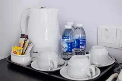 a tray with cups and bottles of water on it at 12FLY Hotel Kuala Lumpur in Kuala Lumpur