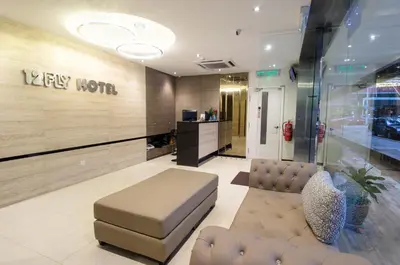 a lobby with a couch and a chair in a store at 12FLY Hotel Kuala Lumpur in Kuala Lumpur