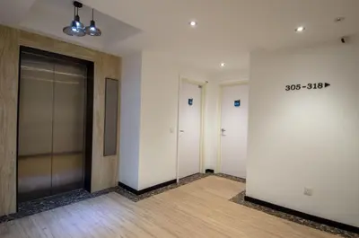 an empty hallway with two elevators in a building at 12FLY Hotel Kuala Lumpur in Kuala Lumpur