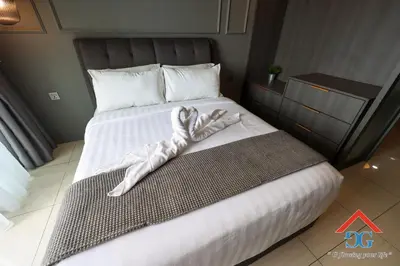 a bedroom with a bed with a towel on it at The Elements by Grabstay in Kuala Lumpur