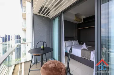 a room with a bed and a table on a balcony at The Elements by Grabstay in Kuala Lumpur