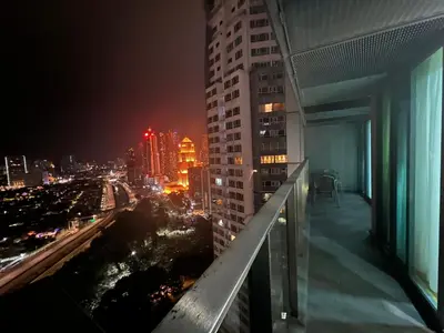 a view of a city at night from the balcony of a building at Mercu Summer Suites KLCC by SS Residence in Kuala Lumpur