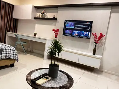 a living room with a tv on a wall at Mercu Summer Suites KLCC by SS Residence in Kuala Lumpur