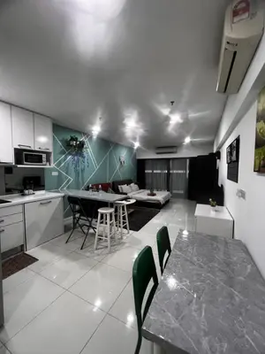 a kitchen and living room with a table and chairs at Mercu Summer Suites KLCC by SS Residence in Kuala Lumpur