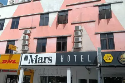 a pink building with a sign for a mans hotel at Mars Hotel in Kuala Lumpur