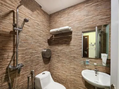 a bathroom with a toilet and a sink at Izumi Hotel Bukit Bintang Kuala Lumpur in Kuala Lumpur