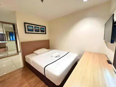 a hotel room with a bed and a television at Seeds Hotel Premier Pudu Kuala Lumpur Previously Hotel Pudu Plaza KL in Kuala Lumpur