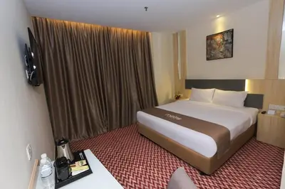 a bedroom with a large bed in a hotel room at Metro Hotel Bukit Bintang in Kuala Lumpur