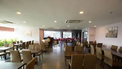 a dining room with tables and chairs in a restaurant at Metro Hotel Bukit Bintang in Kuala Lumpur